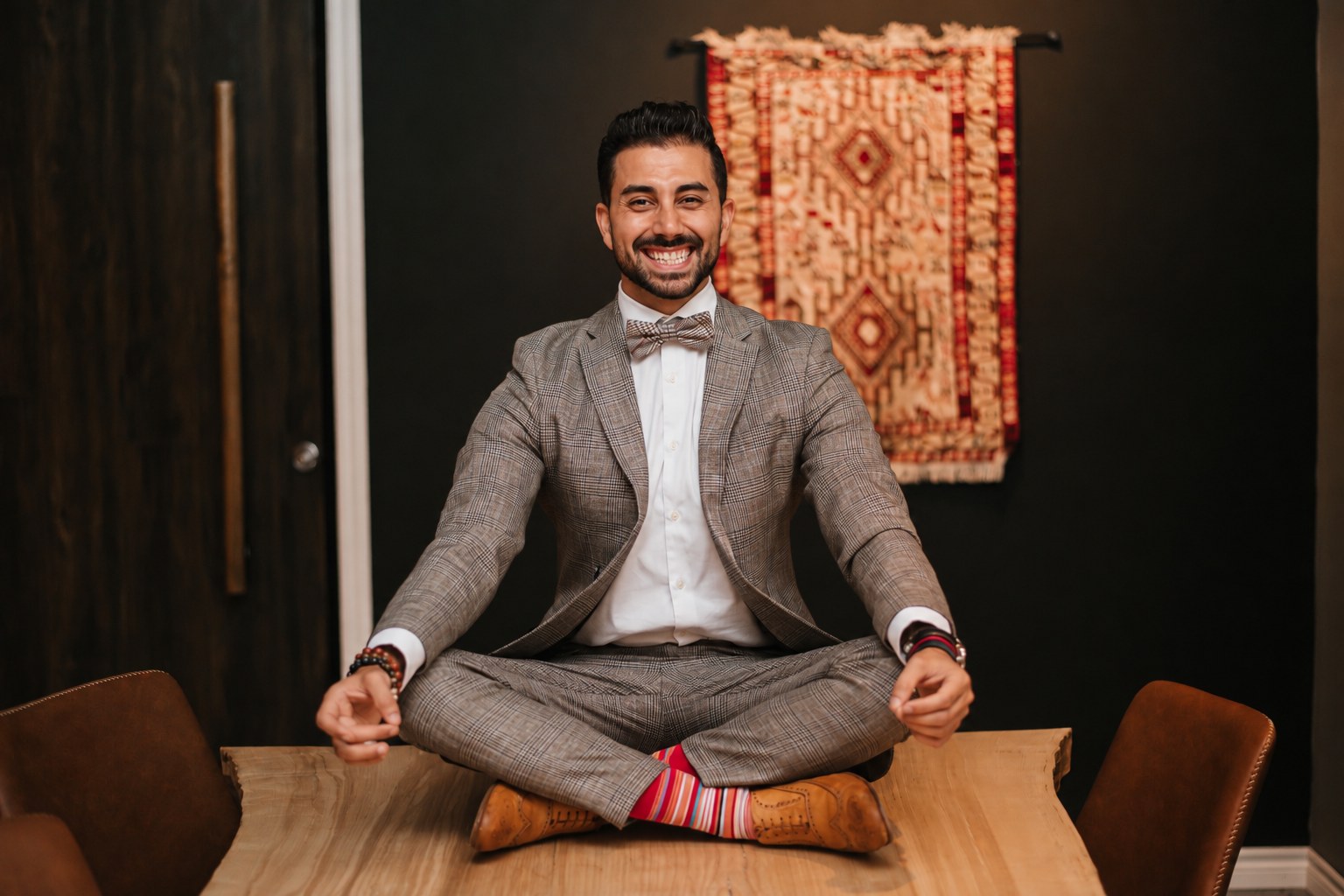 Hoss Notarkesh seated cross-legged on his boardroom table